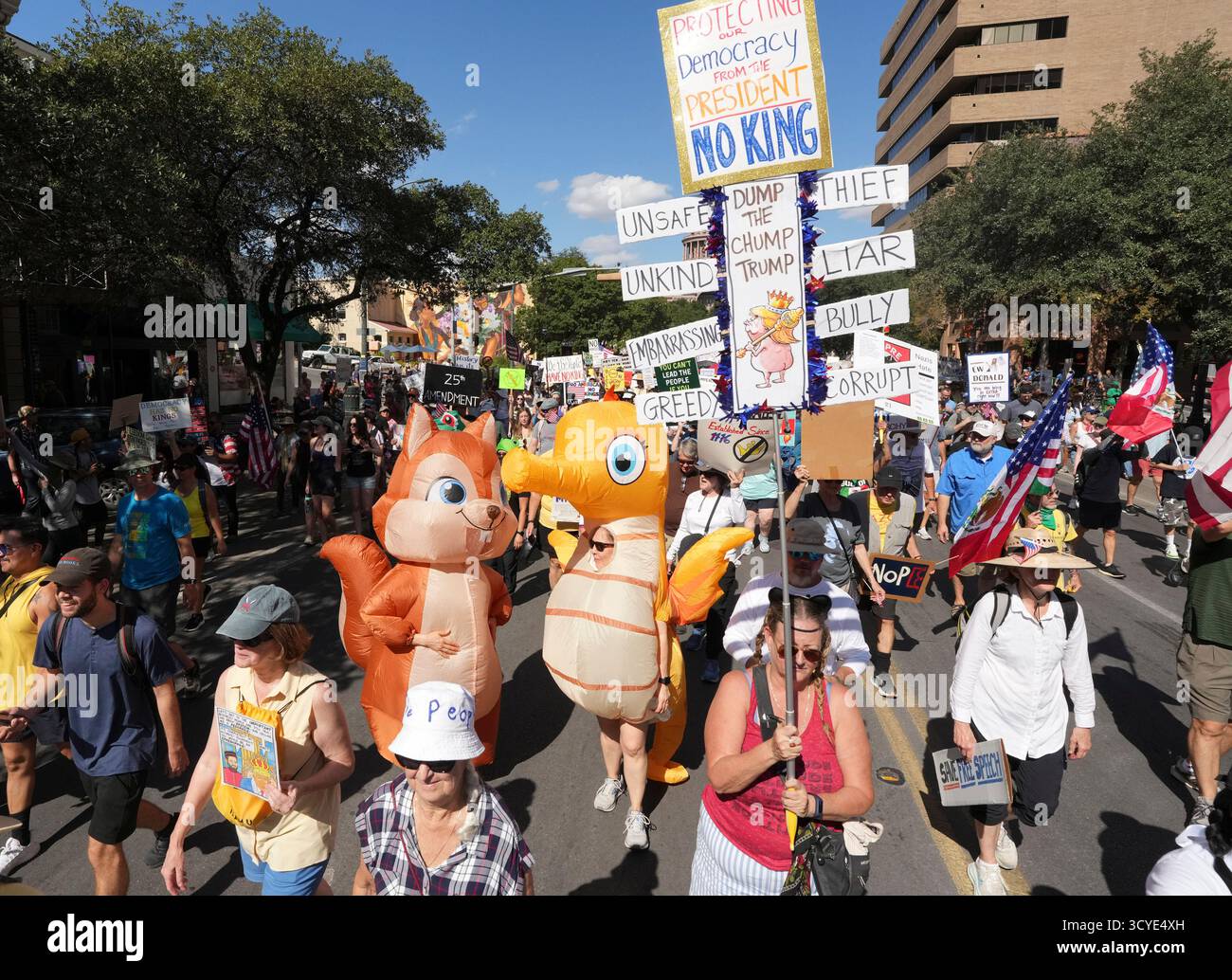 Austin Texas USA, 18 ottobre 2025: Migliaia di manifestanti marciano lungo Congress Avenue durante la manifestazione di protesta "No Kings" contro l'amministrazione del presidente Donald Trump. Greg Abbott, capo del Texas, ha minacciato un lancio della Guardia Nazionale del Texas contro quella che era una protesta ampiamente pacifica monitorata dalla polizia locale. Crediti: Bob Daemmrich/Alamy Live News Foto Stock