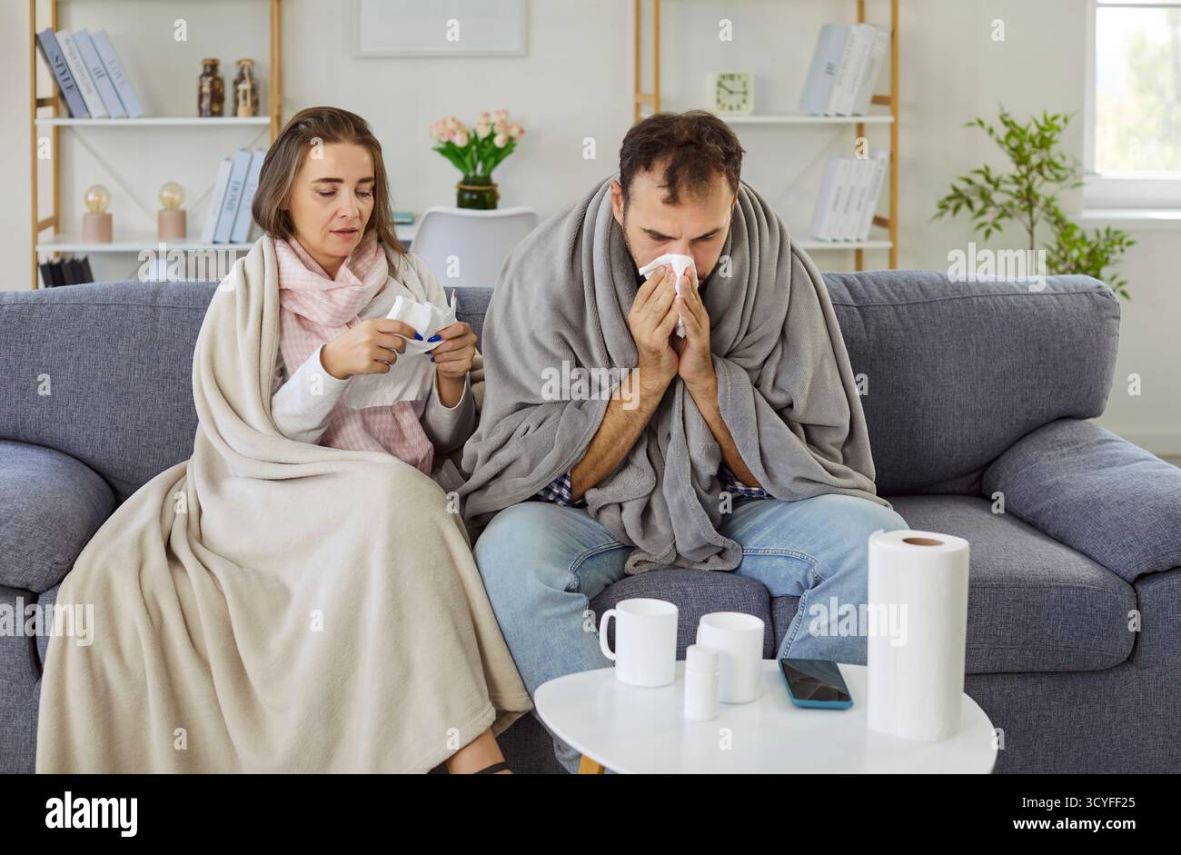 Coppia malata che soffre di febbre e naso che cola, raffreddore e sintomi influenzali a casa Foto Stock