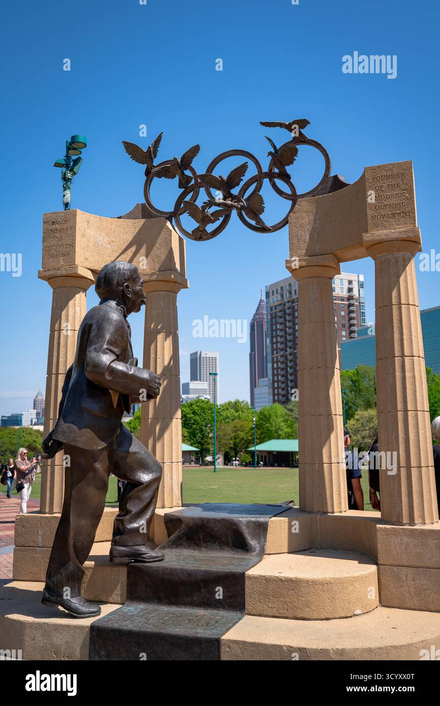 La statua del barone Pierre de Coubertin, fondatore del movimento Olimpico moderno, si trova al Centennial Olympic Park sotto il monumento agli anelli Olimpici Foto Stock