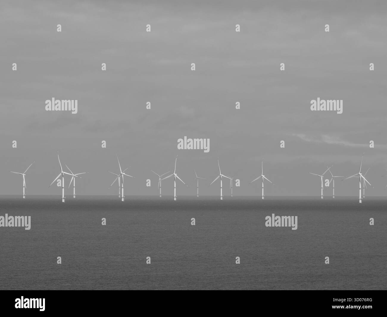 Parco eolico offshore in mare — turbine a energia rinnovabile nell'orizzonte oceanico simboleggiano l'energia sostenibile e il futuro pulito Foto Stock