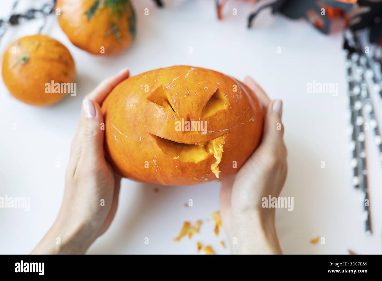 Ottobre 31. Halloween vacanza. La ragazza tiene in mano la faccia scolpita di una zucca. Vista dall'alto Foto Stock