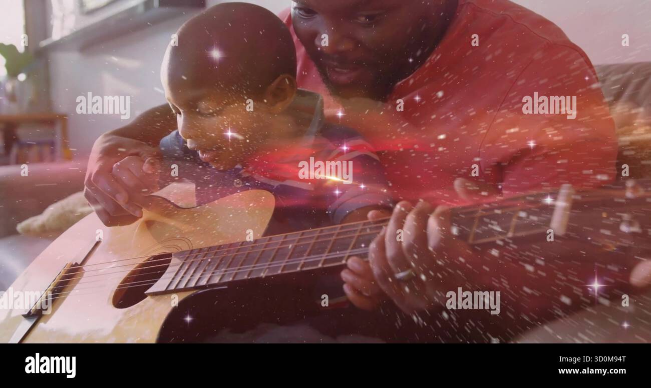 Il padre che guida il ragazzo che mette le dita sulla chitarra acustica sul divano di casa, brilla Foto Stock