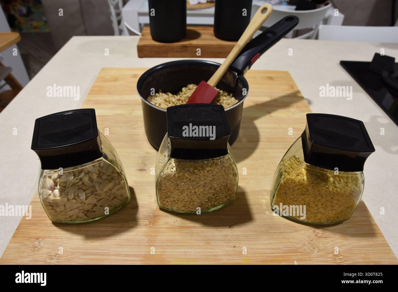 vari tipi di cereali pronti per essere cotti e una pentola contenente cereali già cotti Foto Stock