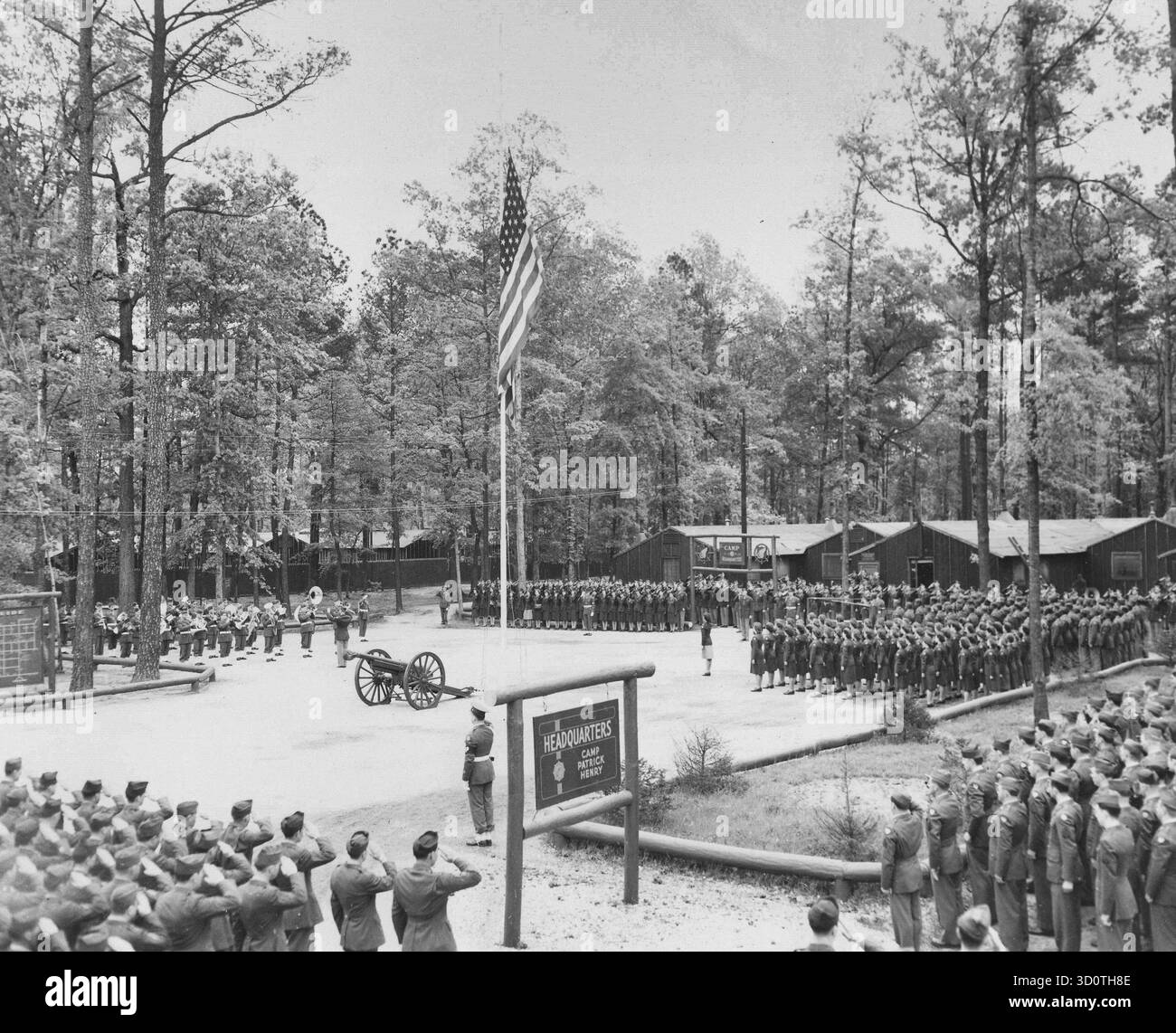 Vista generale del Memorial Service tenuto in onore del defunto presidente Franklin D. Roosevelt a Camp Patrick Henry, Virginia, a cui parteciparono quasi 3.000 ufficiali, uomini e donne arruolati e civili. Le truppe sono mostrate in Present Arms mentre la 469th Army Service Forces Band suona l'inno nazionale. Il servizio, per il quale tutte le truppe del campo erano ammassate in formazione, si tenne intorno al Flagstaff al quartier generale del campo. Fotografia ufficiale U.S. Army Signal Corps, Hampton Roads Port of Embarkation, Newport News, Virginia - 15 aprile 1945 Foto Stock