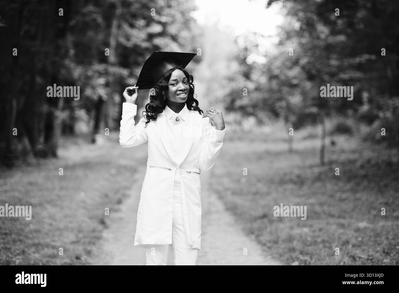 Felice bella africano nero ragazza americana con hat laureati Foto Stock