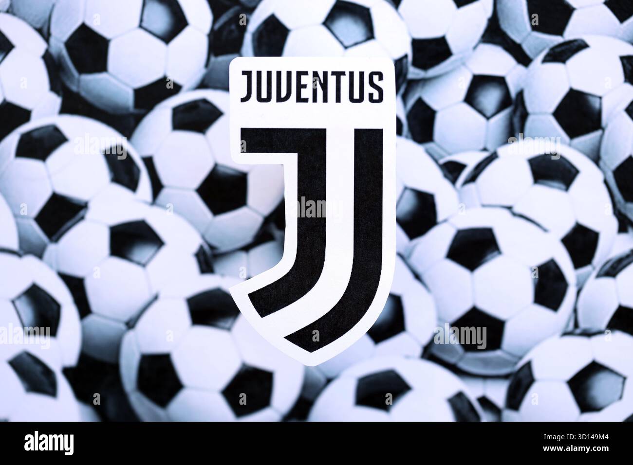 KIEV, UCRAINA - 23 FEBBRAIO 2025 il badge della squadra di calcio della Juventus FC si trova sullo sfondo delle palle da calcio Foto Stock