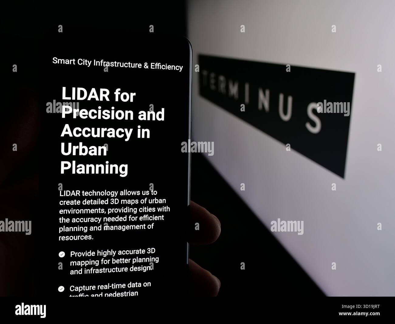 Stoccarda, Germania - 24-10-2025: Persona che detiene il cellulare con pagina web della società di estrazione dati Terminus Technologies sullo schermo davanti al logo. Foto Stock