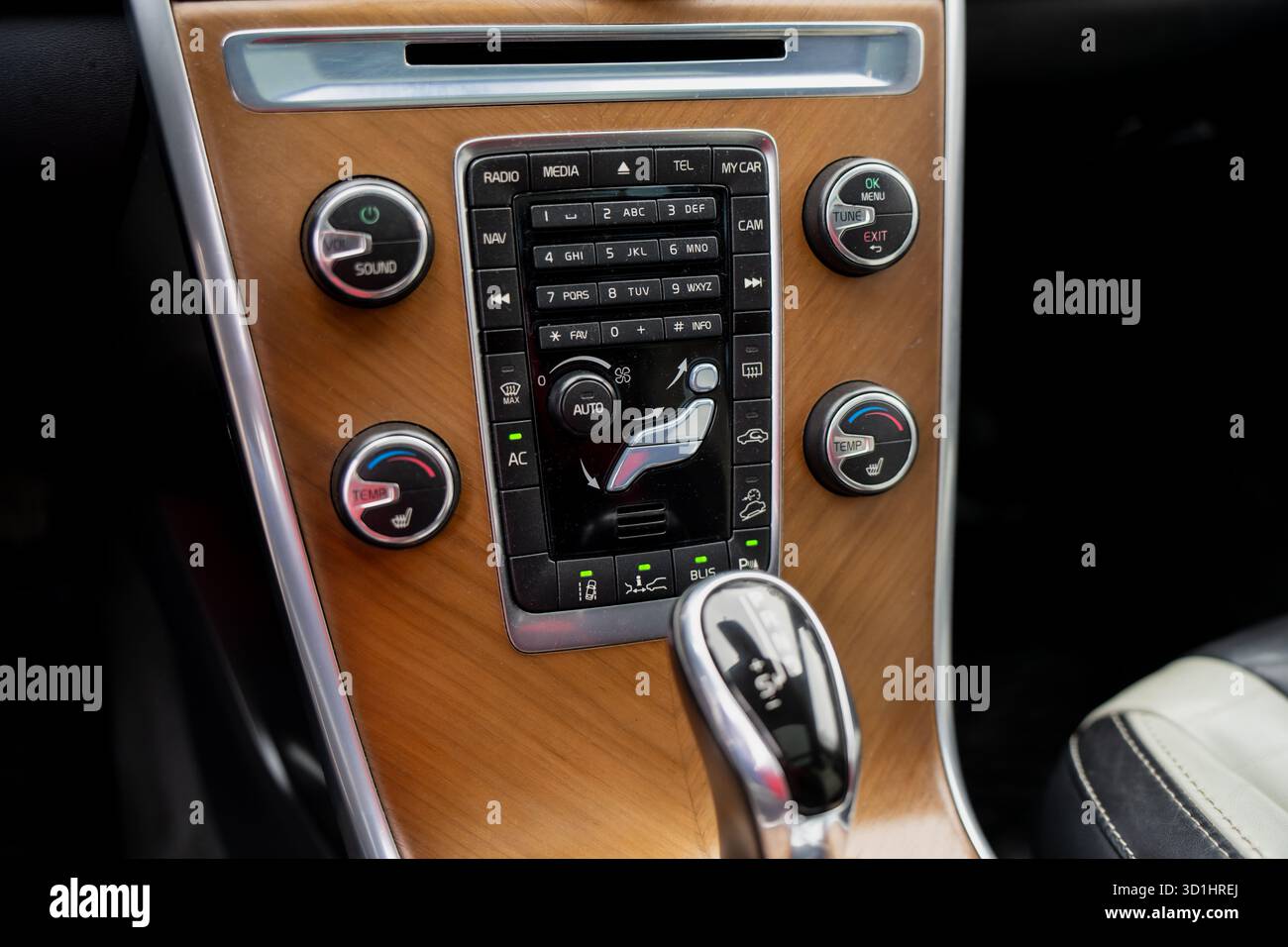 Cruscotto moderno per auto con elegante pannello in legno, sistema di controllo multifunzione e selettore automatico del cambio che enfatizza comfort e raffinatezza Foto Stock