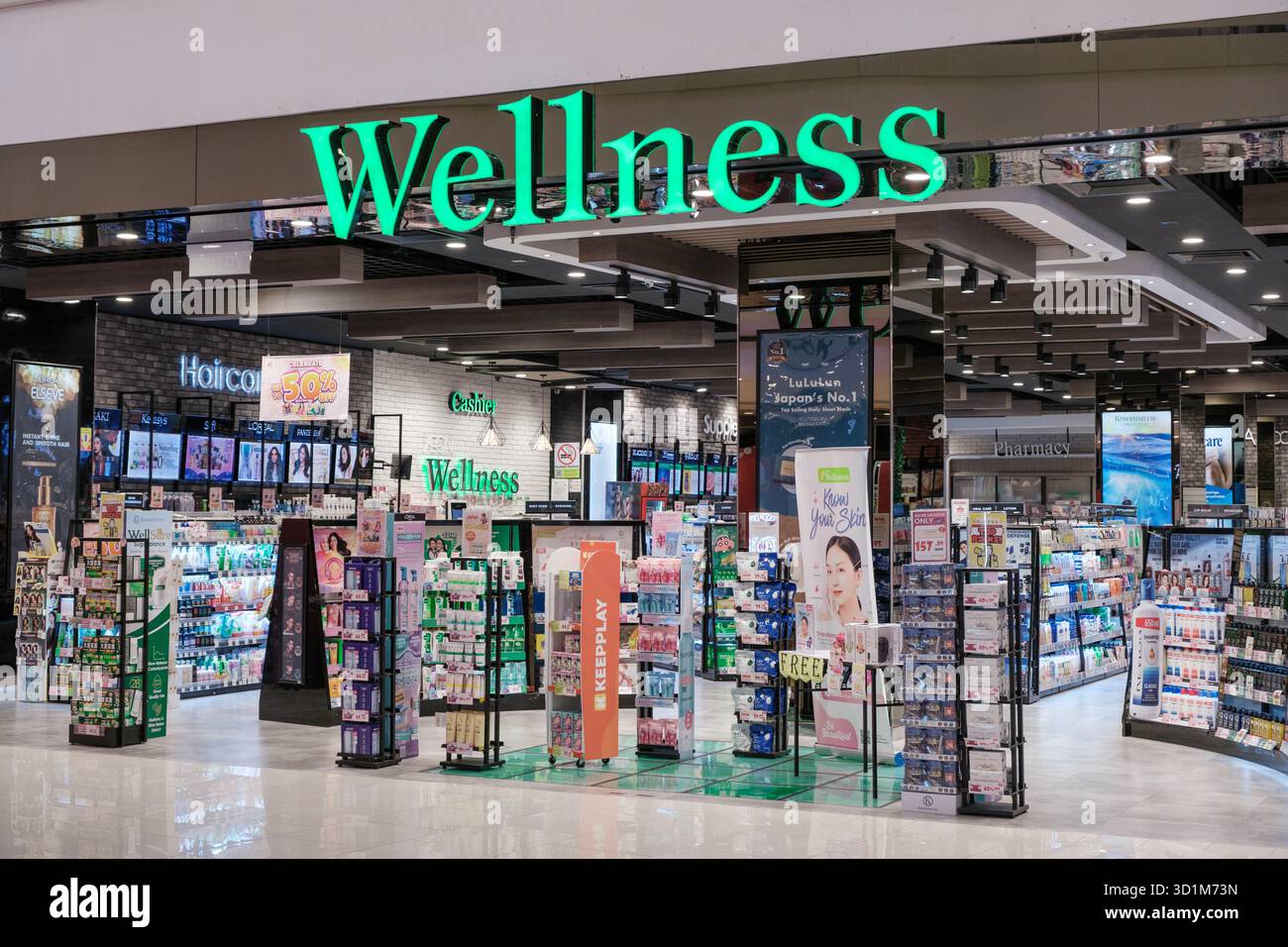 Un negozio Wellness espone una varietà di prodotti per la salute e la bellezza in imballaggi luminosi, disposti su scaffali con illuminazione vibrante che mette in risalto il prodotto Foto Stock