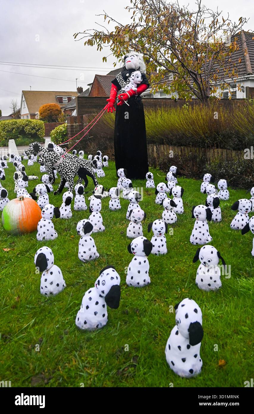 Worthing UK 29 ottobre 2025 - Cruella Deville e Dalmati partecipano a questo festival dello spaventapasseri del villaggio di Ferring vicino Worthng nel West Sussex . Oltre 50 spaventapasseri sono stati eretti intorno al villaggio per contribuire a sostenere quest'anno beneficenza che è la campagna Men in Sheds per la salute mentale: Credit Simon Dack /Alamy Live News Foto Stock