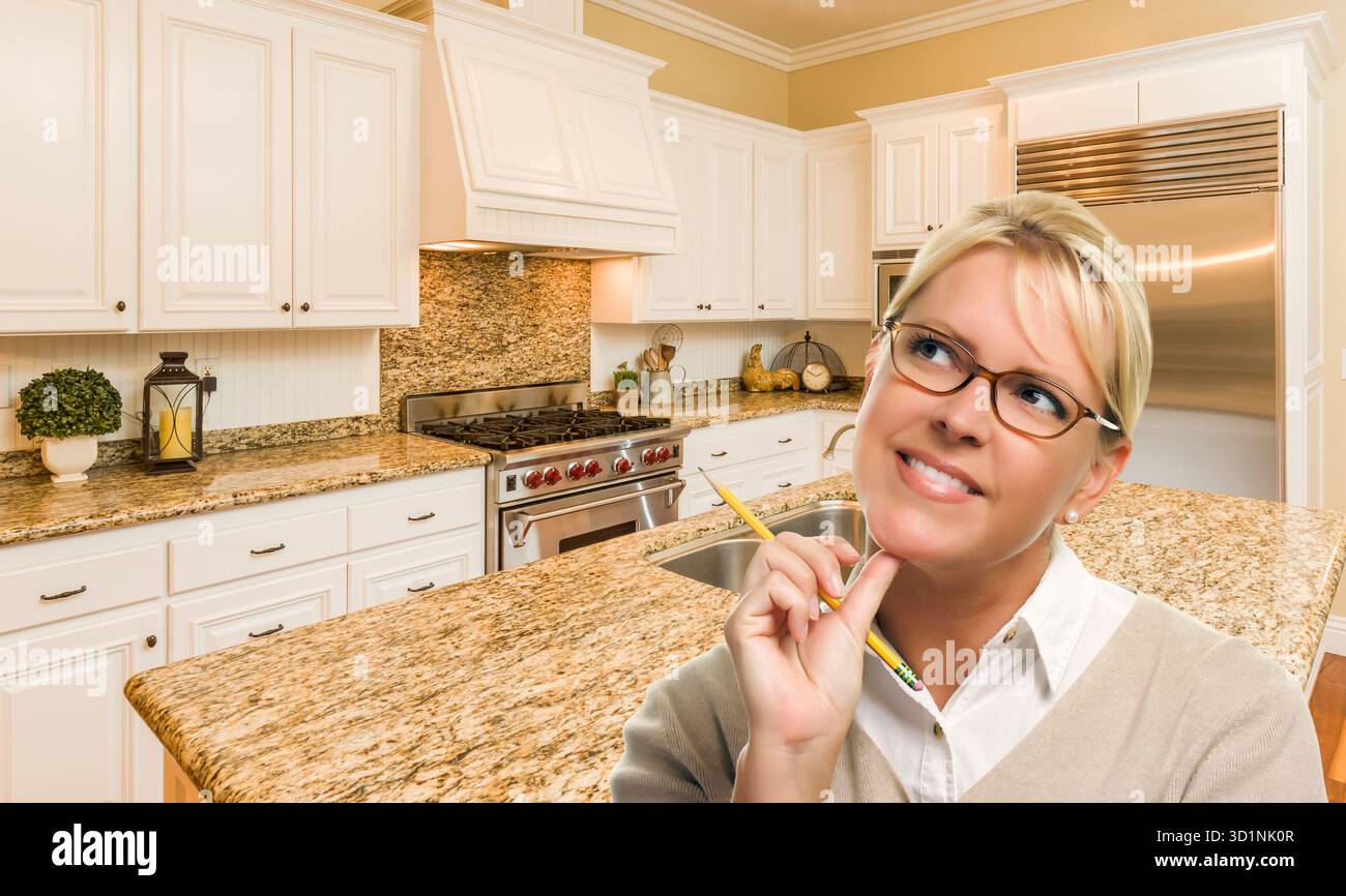 Donna da sogno con matita all'interno della splendida cucina personalizzata Foto Stock