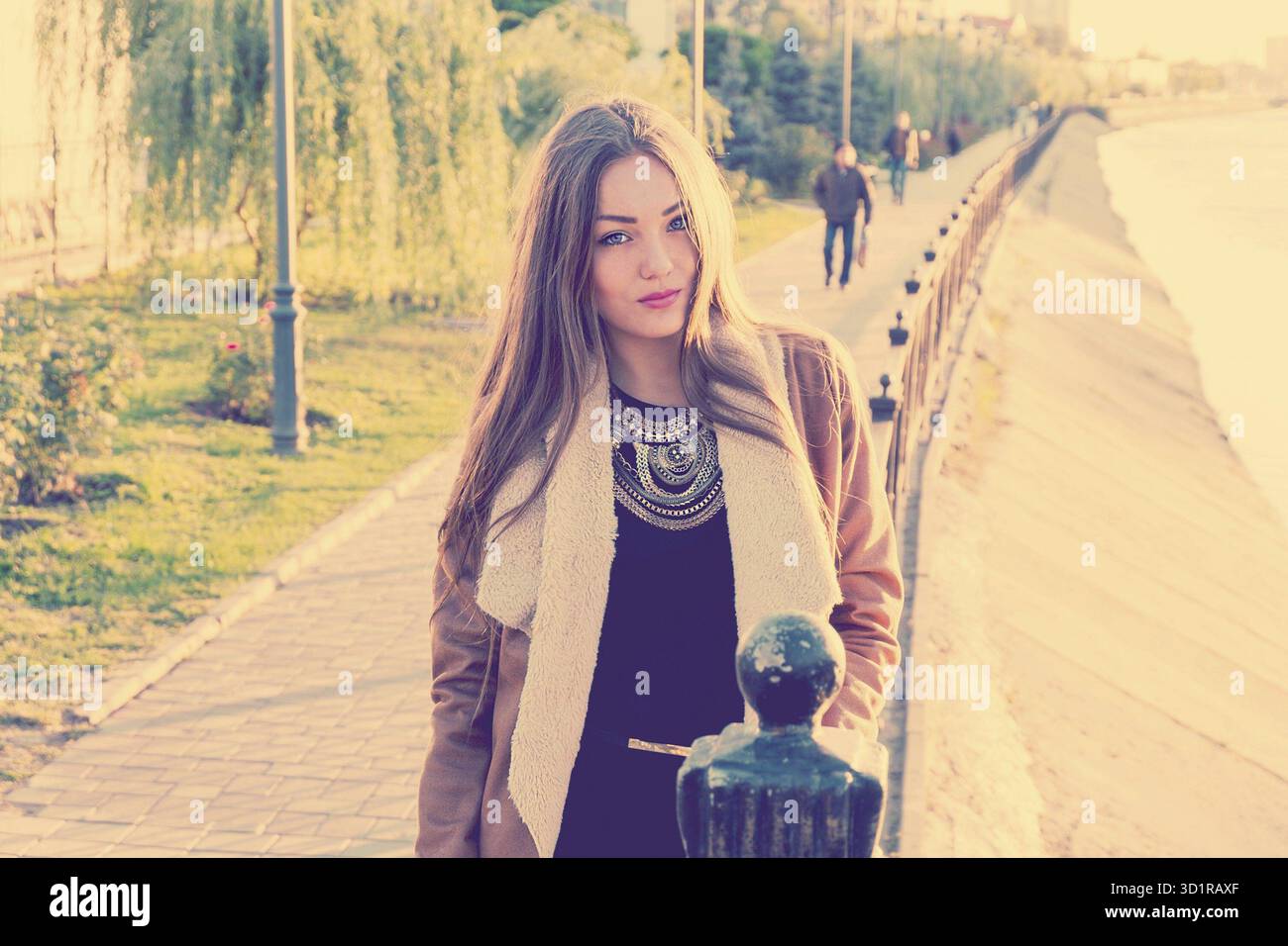 Ritratto di una bella ragazza contro l'acqua, colore del film, stile instagram. Triste ragazza infelice in autunno, stress, depressione Foto Stock