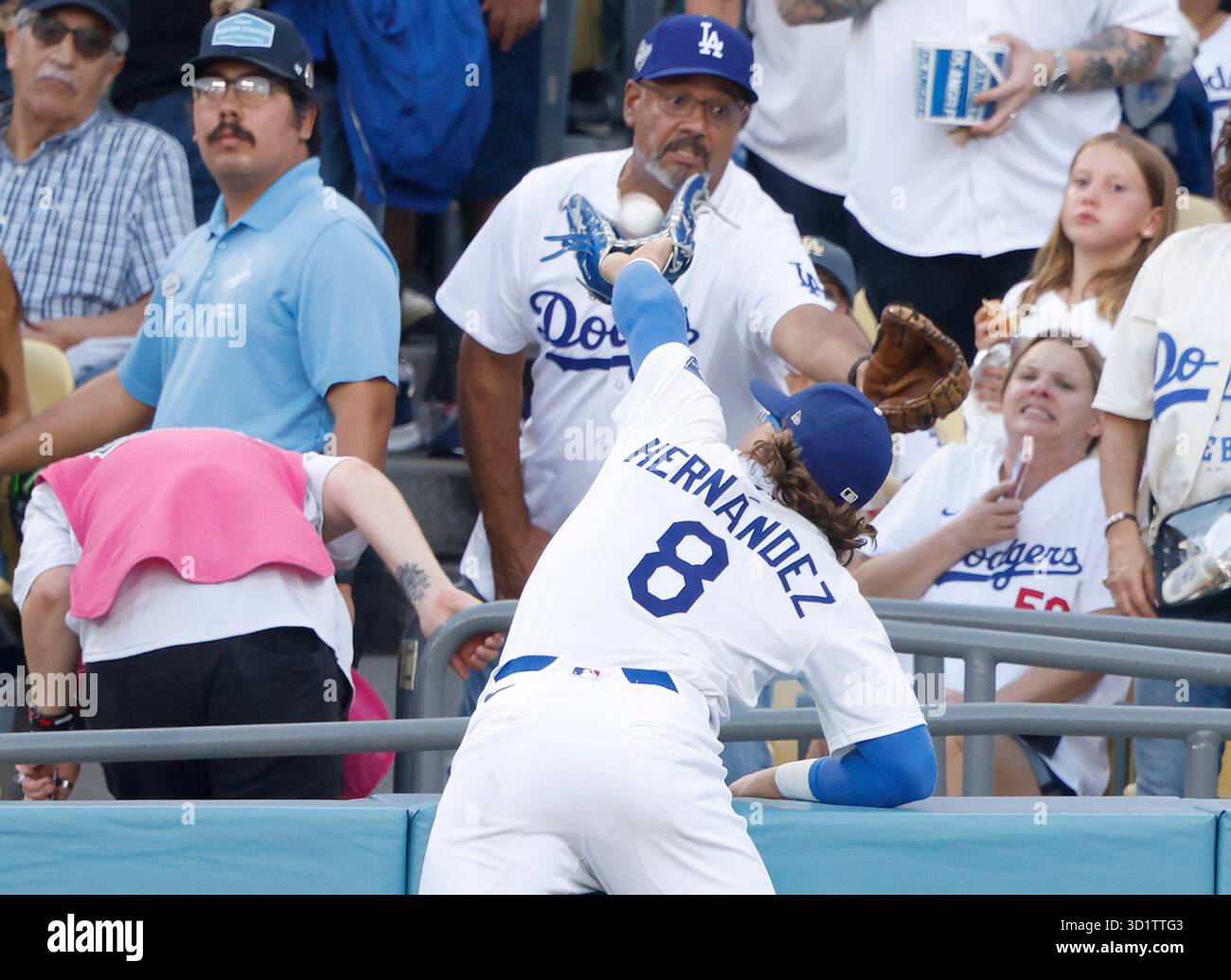 Los Angeles, Stati Uniti. 28 ottobre 2025. I Los Angeles Dodgers hanno lasciato l'esterno Enrique Hernandez (8) salta tra la folla per prendere un pallone foul dai Toronto Blue Jays Nathan Lukes nel primo inning durante la partita quattro delle MLB World Series al Dodger Stadium di Los Angeles martedì 28 ottobre 2025. Foto di John Angelillo/UPI credito: UPI/Alamy Live News Foto Stock