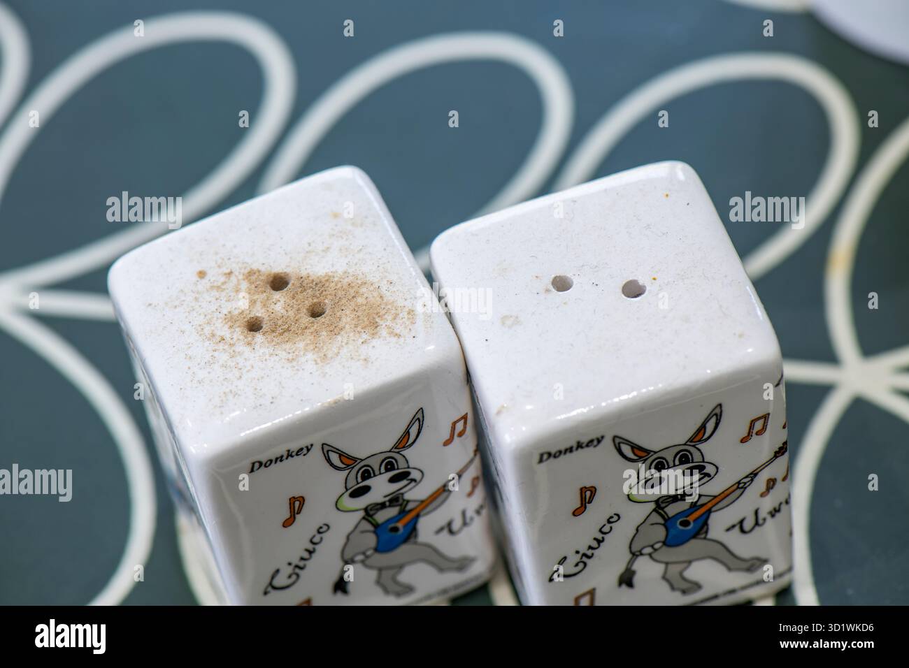 pentole di sale e pepe in ceramica decorate con asini cartoni. Cuocere su un tavolo per condire e aromatizzare gli alimenti. Agitatori per sale e pepe. Foto Stock