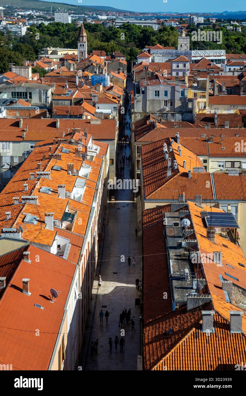 Vista aerea di uno stretto vicolo fiancheggiato da edifici storici dal tetto arancione in una giornata di sole, Zara, Croazia. Foto Stock