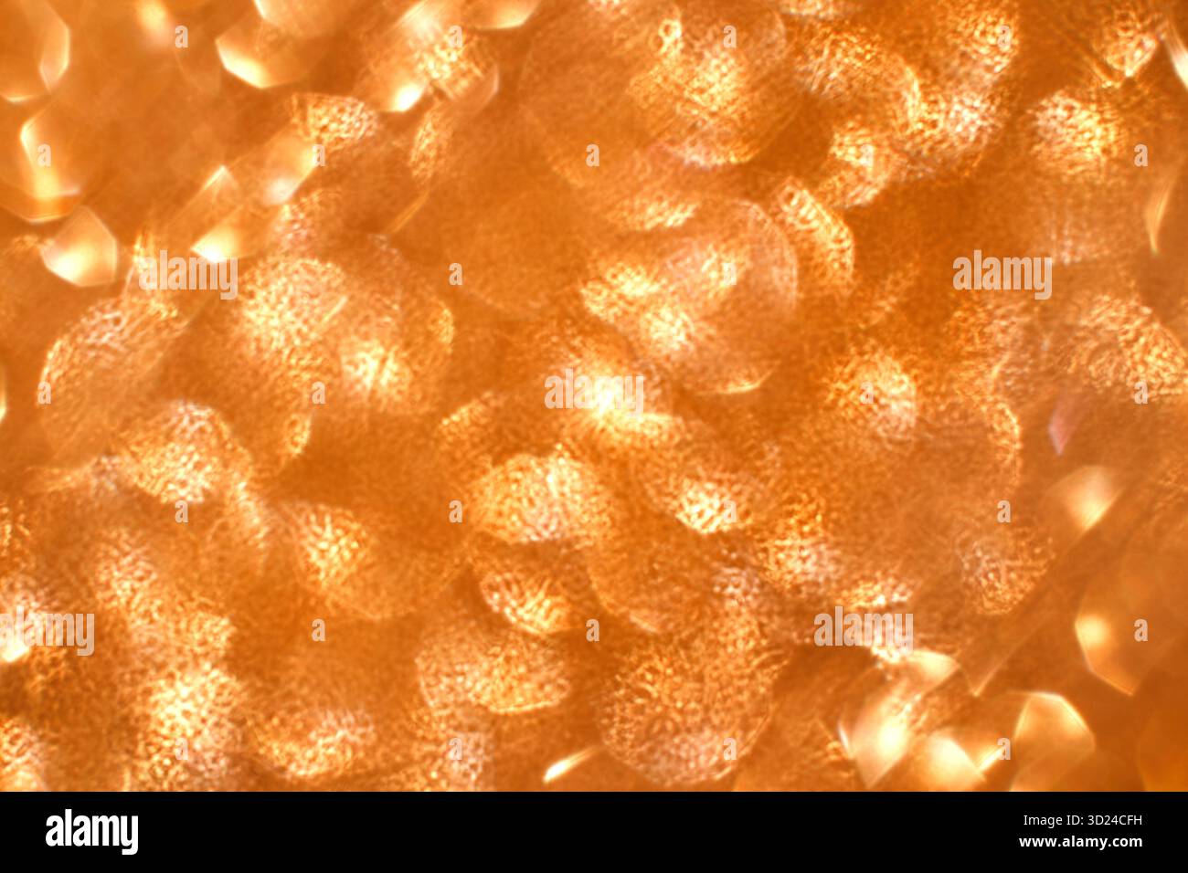 Motivo astratto di riflessi di luce arancione e oro che creano un caldo Foto Stock