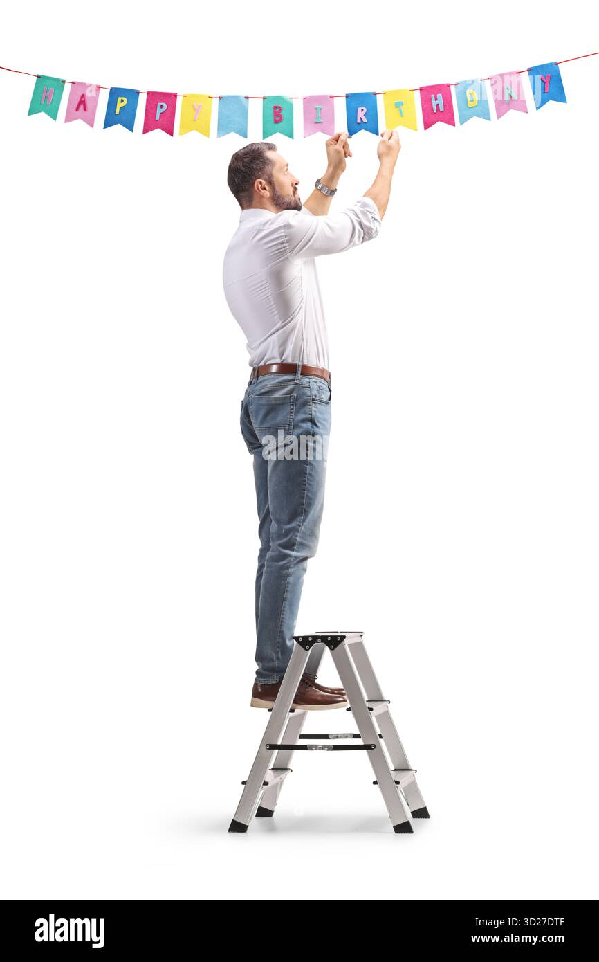 Uomo che appende decorazioni di compleanno isolate su sfondo bianco Foto Stock