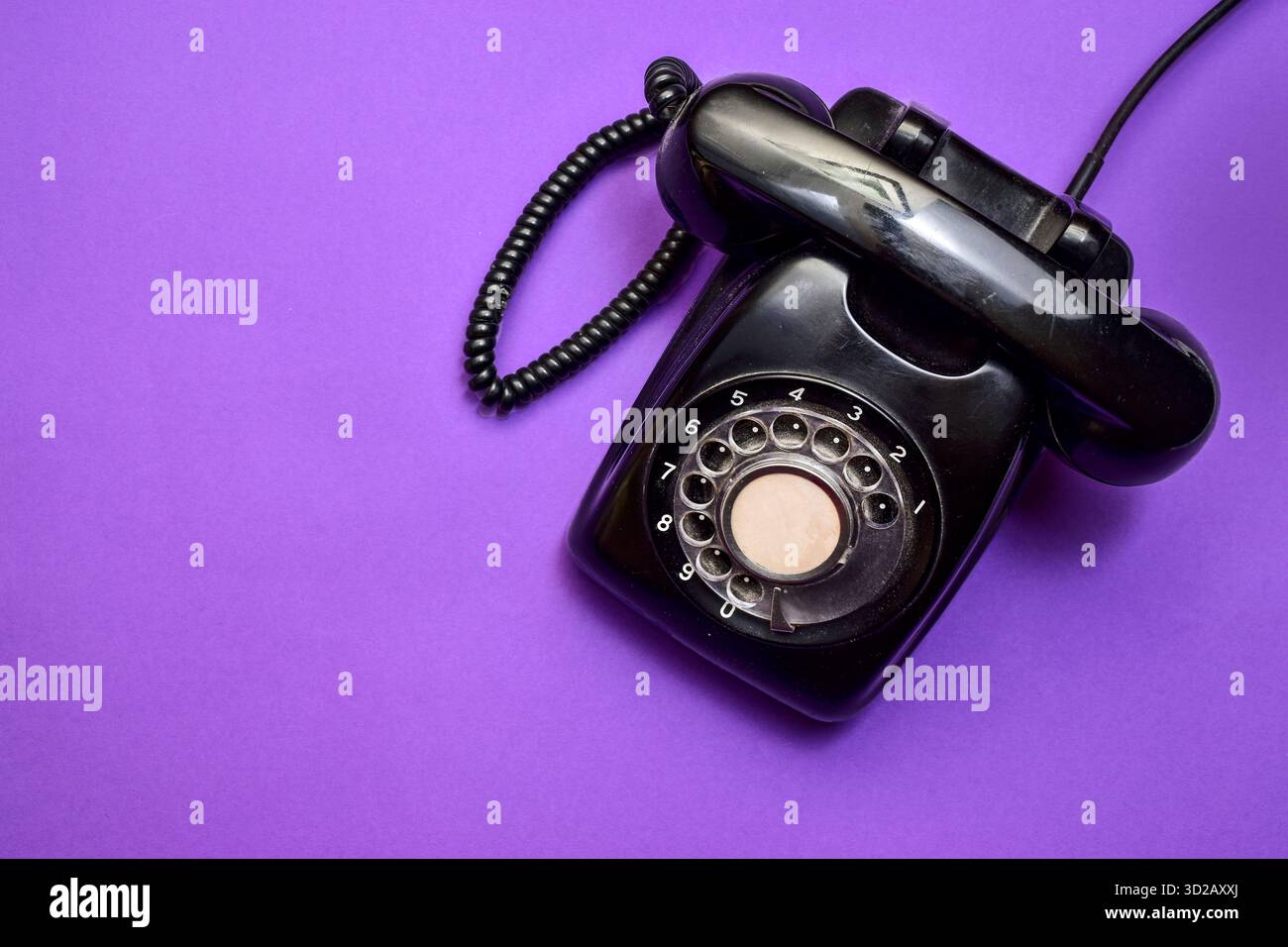 Uno spazio di lavoro moderno con un computer portatile, uno smartphone e un tablet E un telefono fisso classico Foto Stock