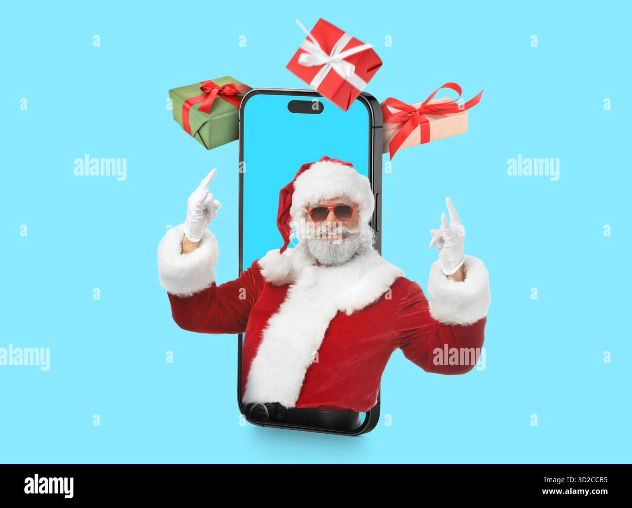Cellulare con Babbo Natale sullo schermo e regali su sfondo blu Foto Stock