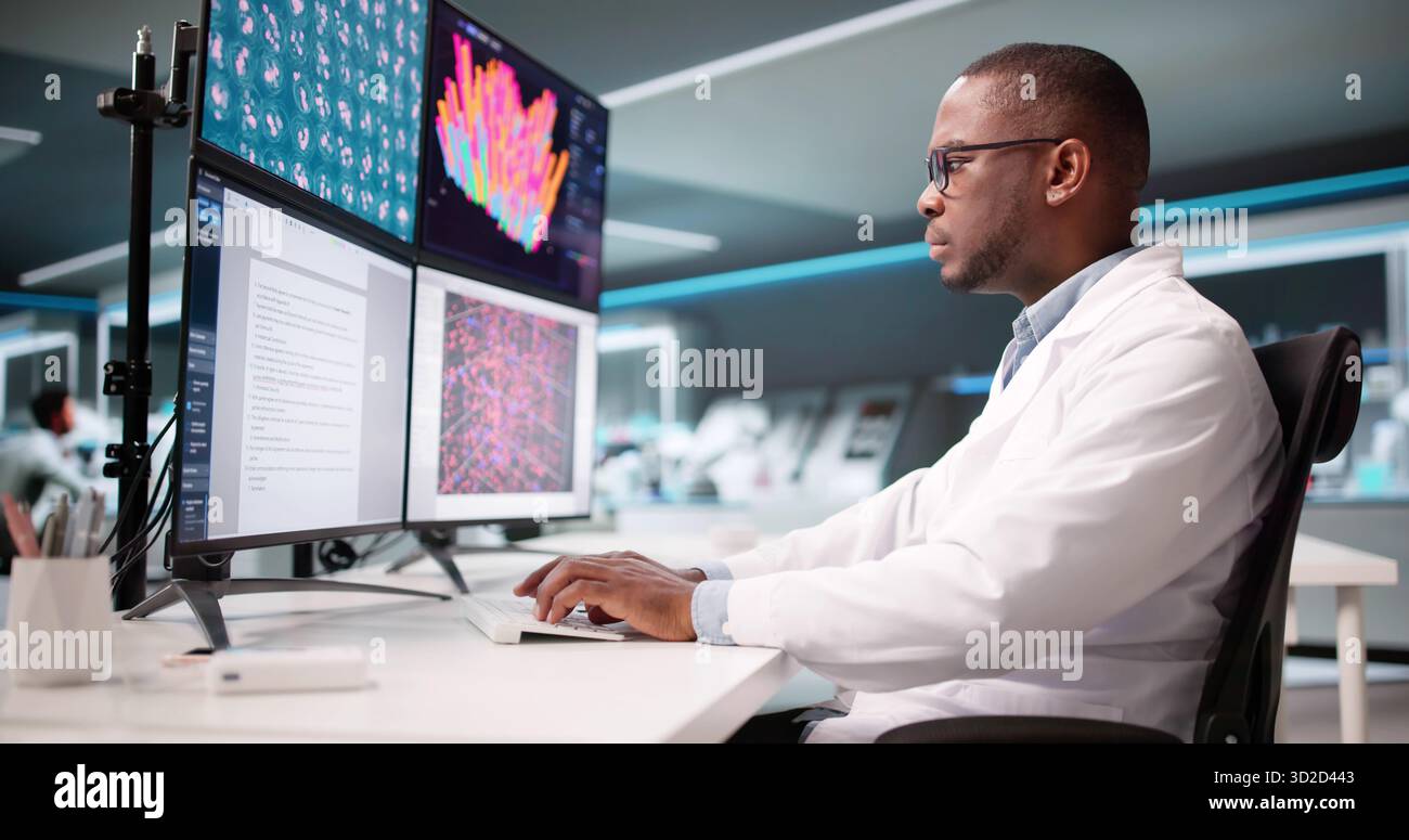 African American Scientist in Lab Writing Research Paper on multiple Screens. Foto Stock