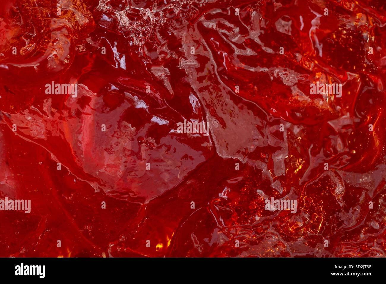 Struttura gelatina gelatina di fragole rosse, consistenza culinaria rossa astratta, primo piano Foto Stock