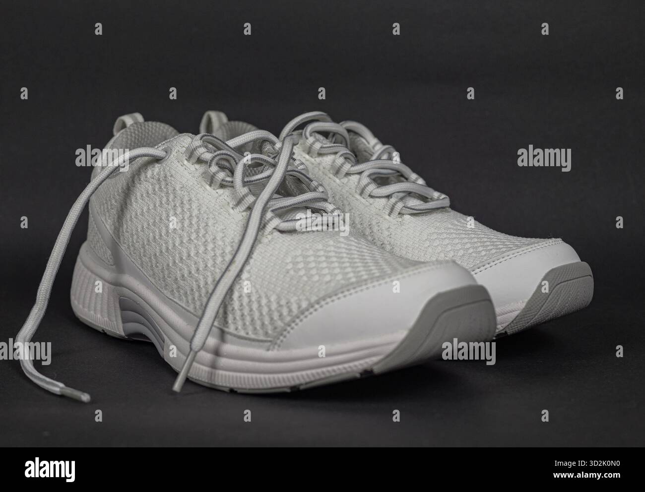 Sneaker con lacci bianche da donna, perfette per camminare nelle calde giornate di sole Foto Stock