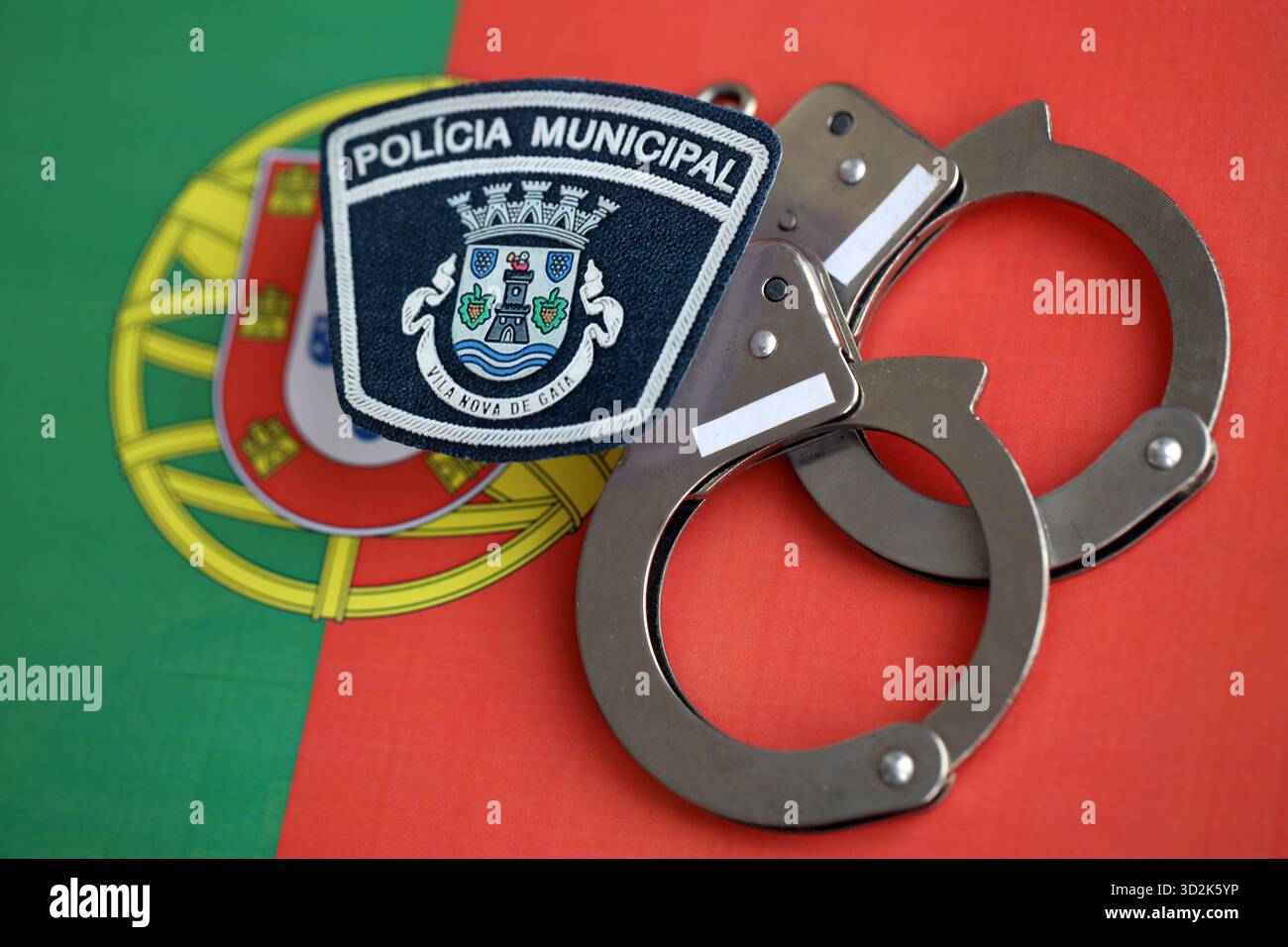 KIEV, UCRAINA - 6 SETTEMBRE 2025 Portogallo polizia municipale patch e manette sulla bandiera nazionale primo piano Foto Stock