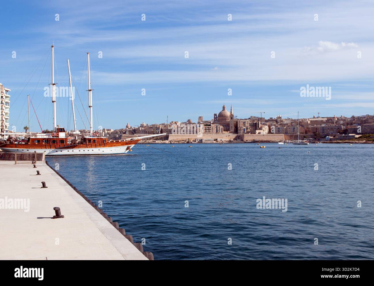 Goletta tradizionale nel porto di Sliema, con lo skyline di la Valletta, Malta Foto Stock