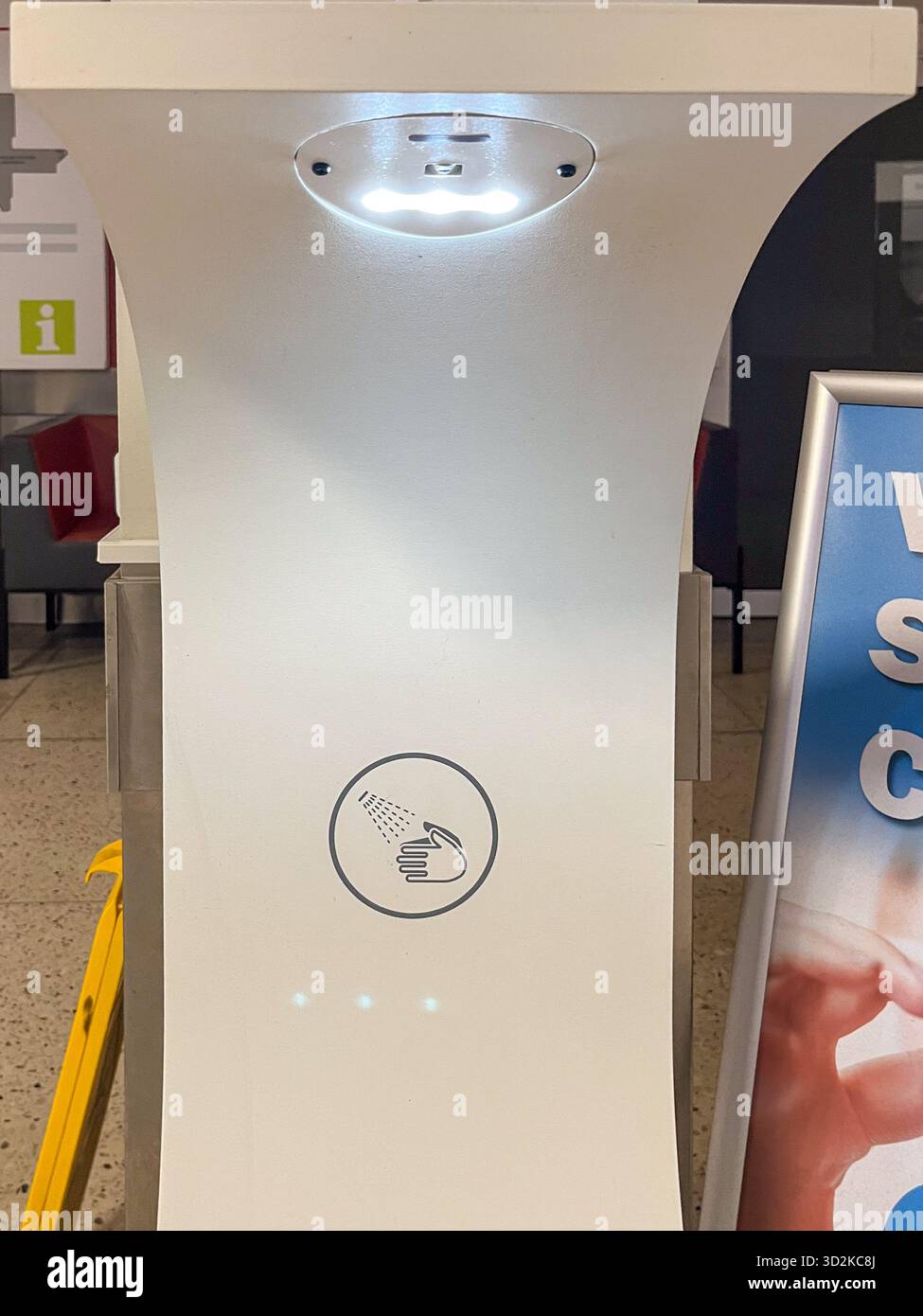 La moderna stazione igienizzante per le mani è dotata di sensore illuminato e design minimalista, che promuove l'igiene e la sicurezza nelle aree pubbliche, migliorando l'efficienza dell'utente Foto Stock