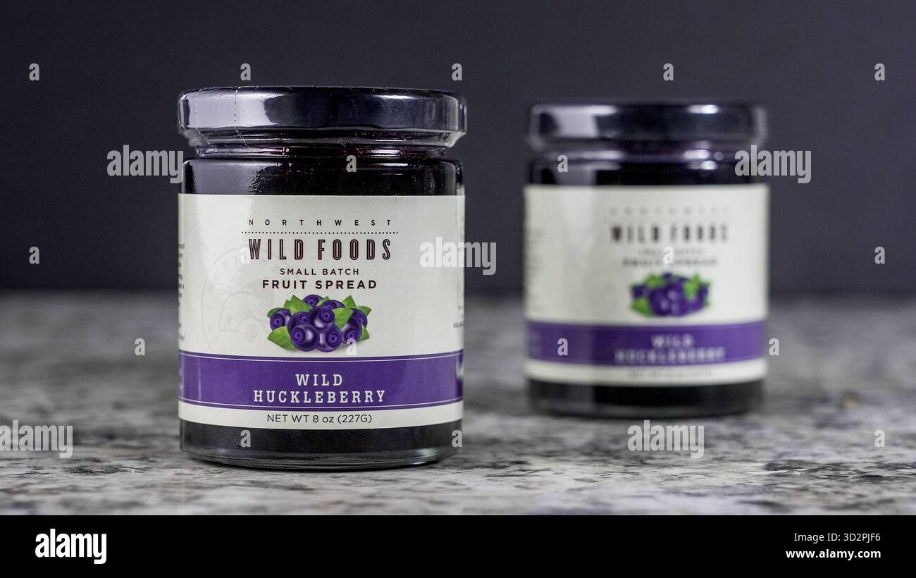 NORWALK, CT, USA - 30 OTTOBRE 2025: Due vasetti di frutta di ucoccola selvatica si trovano su un piano di cucina in marmo. Il colore intenso dell'Highli diffuso Foto Stock