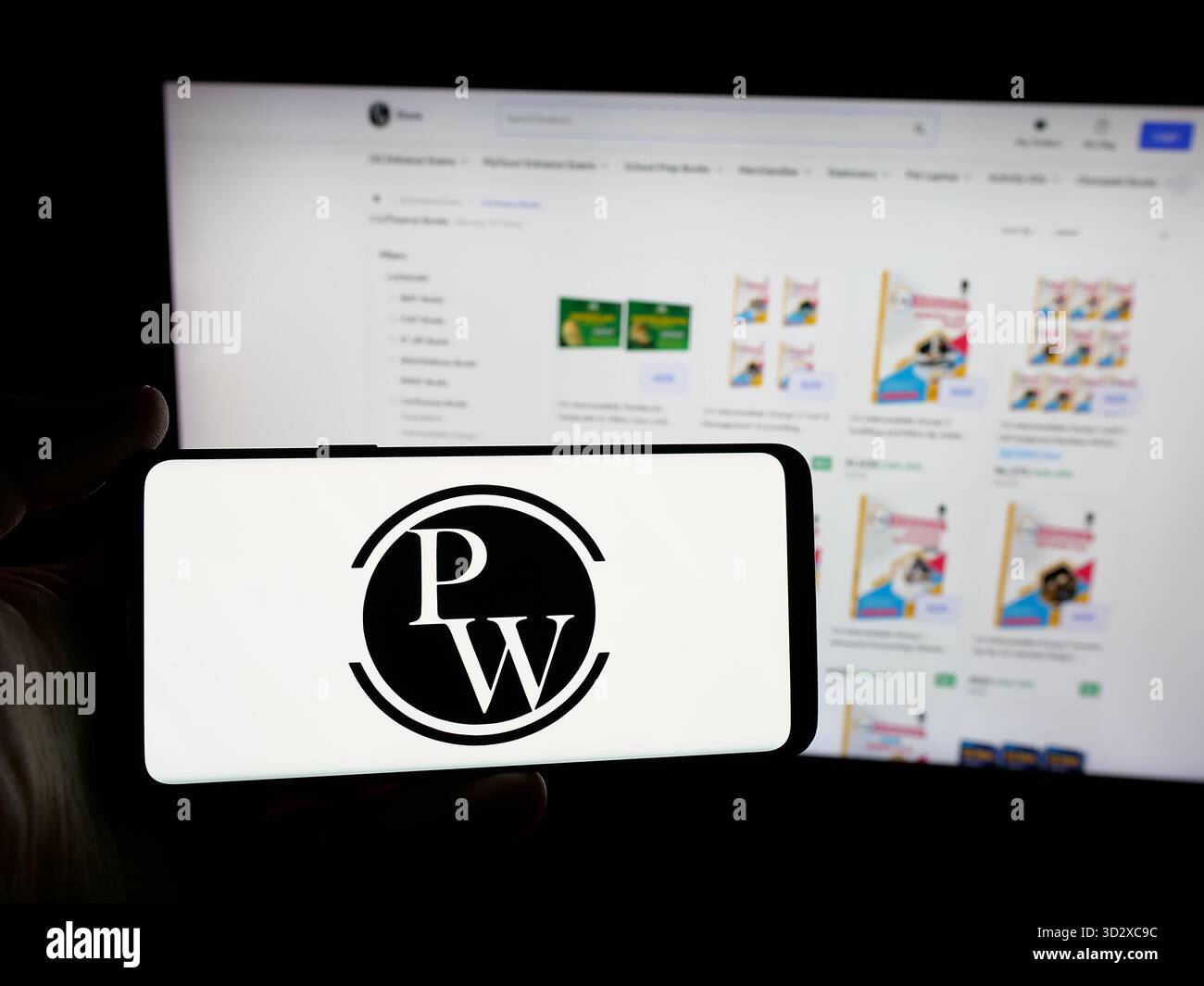 Stoccarda, Germania - 10-25-2025: Persona con smartphone con logo della società indiana Physics Wallah Limited (PW) sullo schermo davanti al sito web. Foto Stock