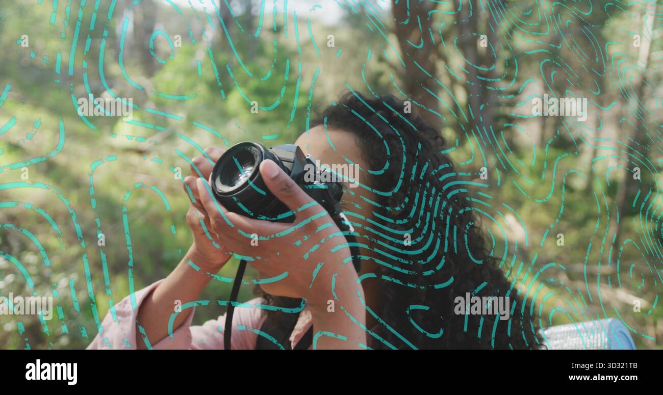 Donna adulta in giacca rosa che inquadra in legno, con cinturino per fotocamera DSLR e linee turchesi Foto Stock