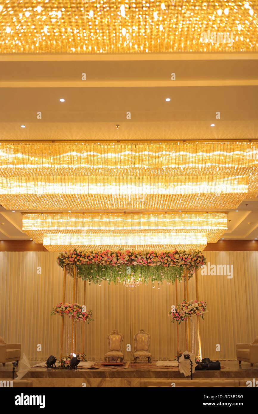 Un allestimento mandap splendidamente progettato per la sposa e lo sposo, che simboleggia la celebrazione e la grandiosità dei matrimoni indiani. Foto Stock