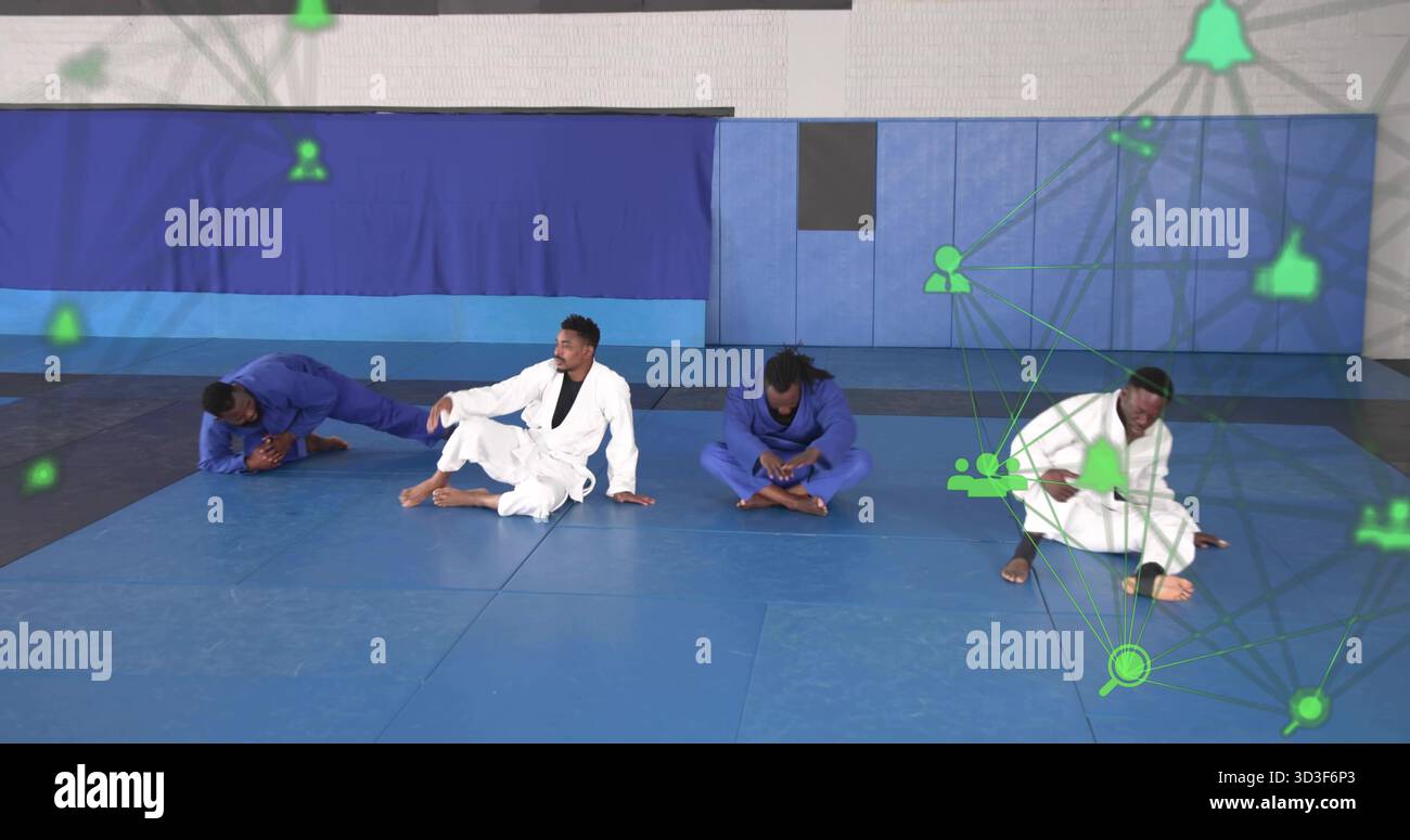 Artisti di arti marziali che indossano gis sui tappetini in palestra con pareti imbottite e icone verdi della rete Foto Stock