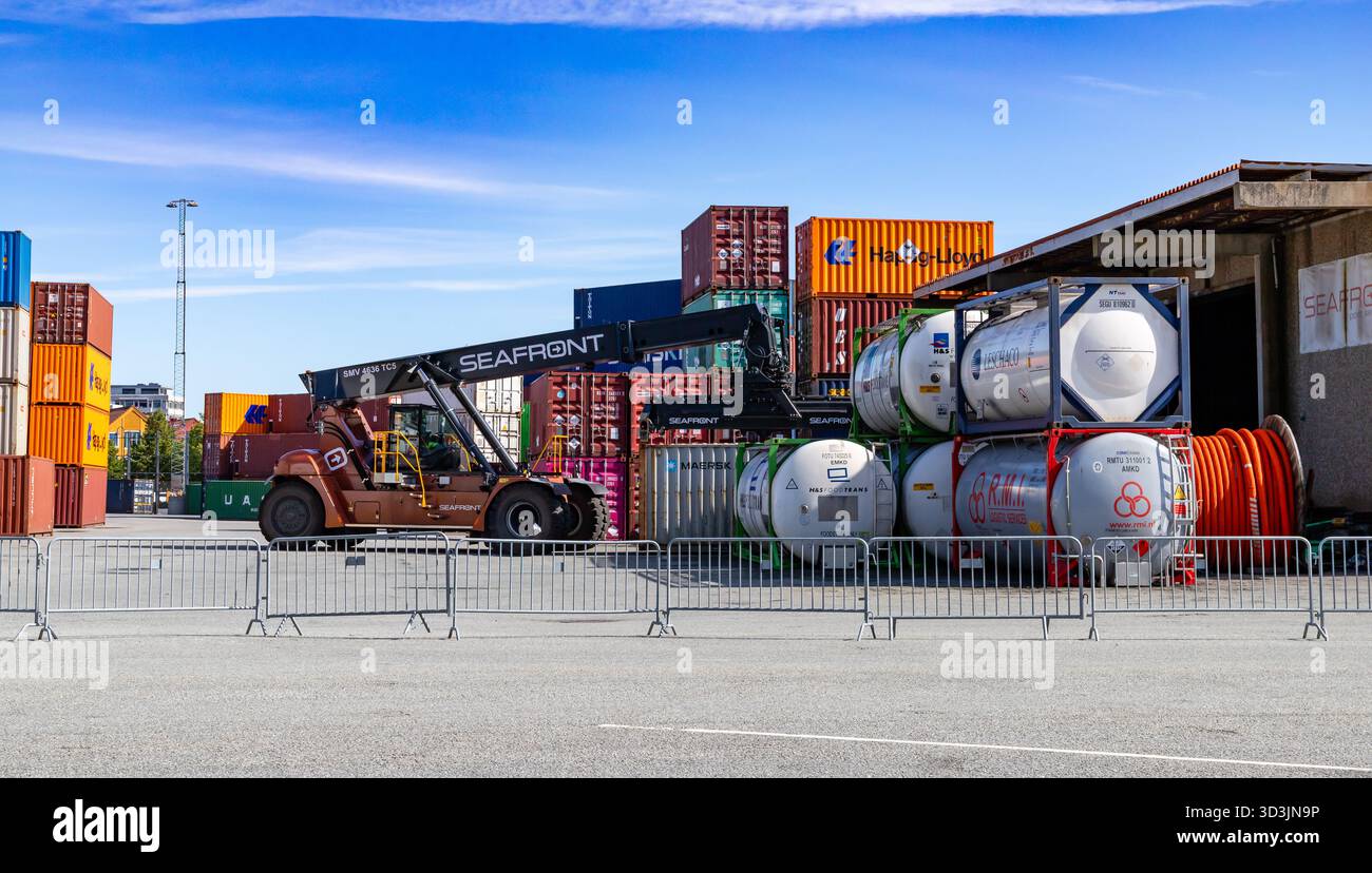 Kristiansand, Norvegia - 12 agosto 2025: Movimentazione di container cisterna sul lungomare Foto Stock