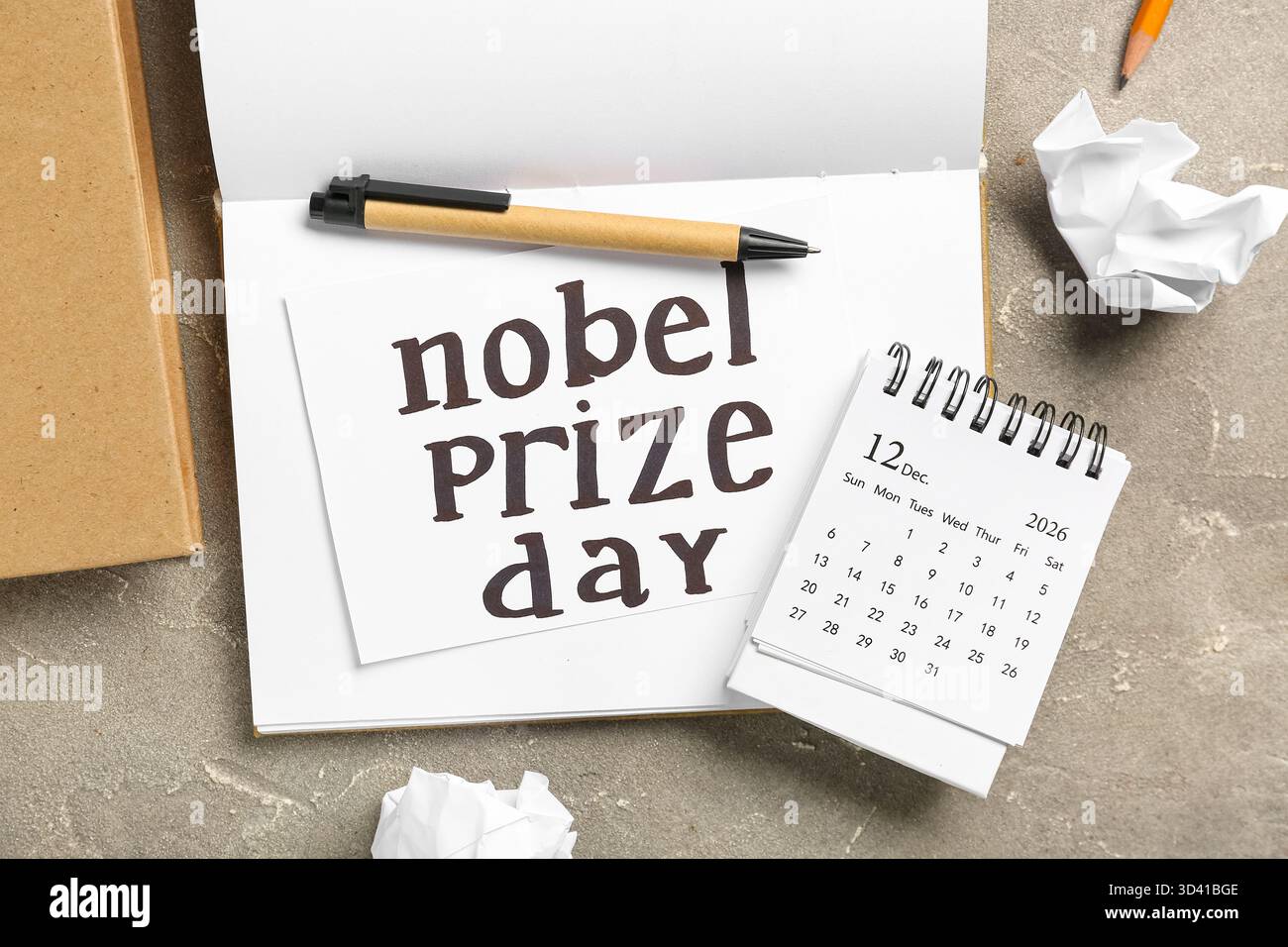 Libro con testo GIORNO DEL PREMIO NOBEL e calendario su sfondo grunge Foto Stock