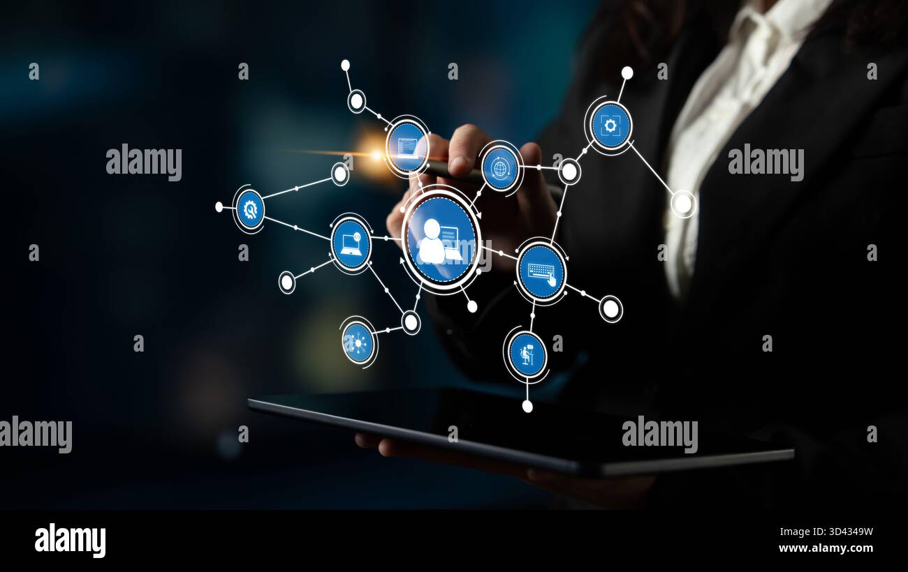 Un professionista utilizza un touchscreen per interagire con i nodi di rete, dimostrando l'intersezione tra tecnologia e comunicazione aziendale in un ambiente moderno Foto Stock