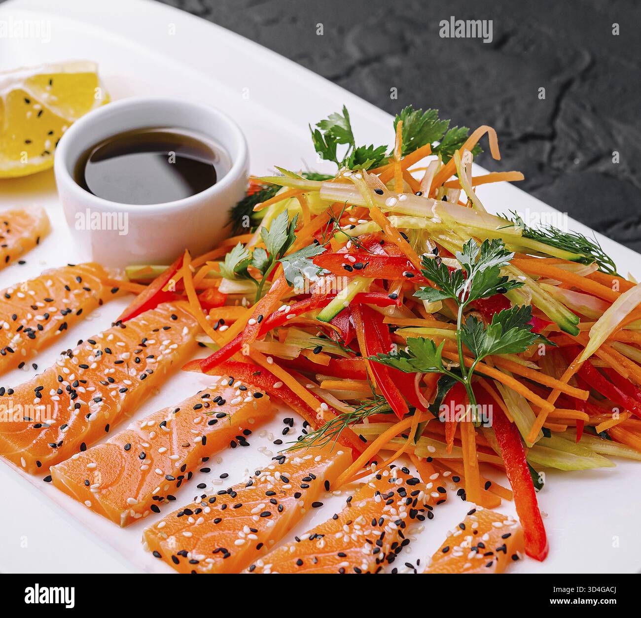 Cibo, fette di salmone con insalata di carote e peperoni e salsa di soia - cucina asiatica Foto Stock