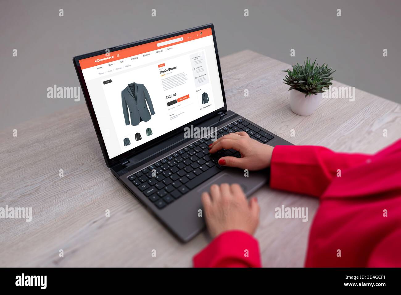 Shopping online per il blazer maschile utilizzando il concetto di notebook, retail digitale ed e-commerce in un ambiente di lavoro moderno Foto Stock