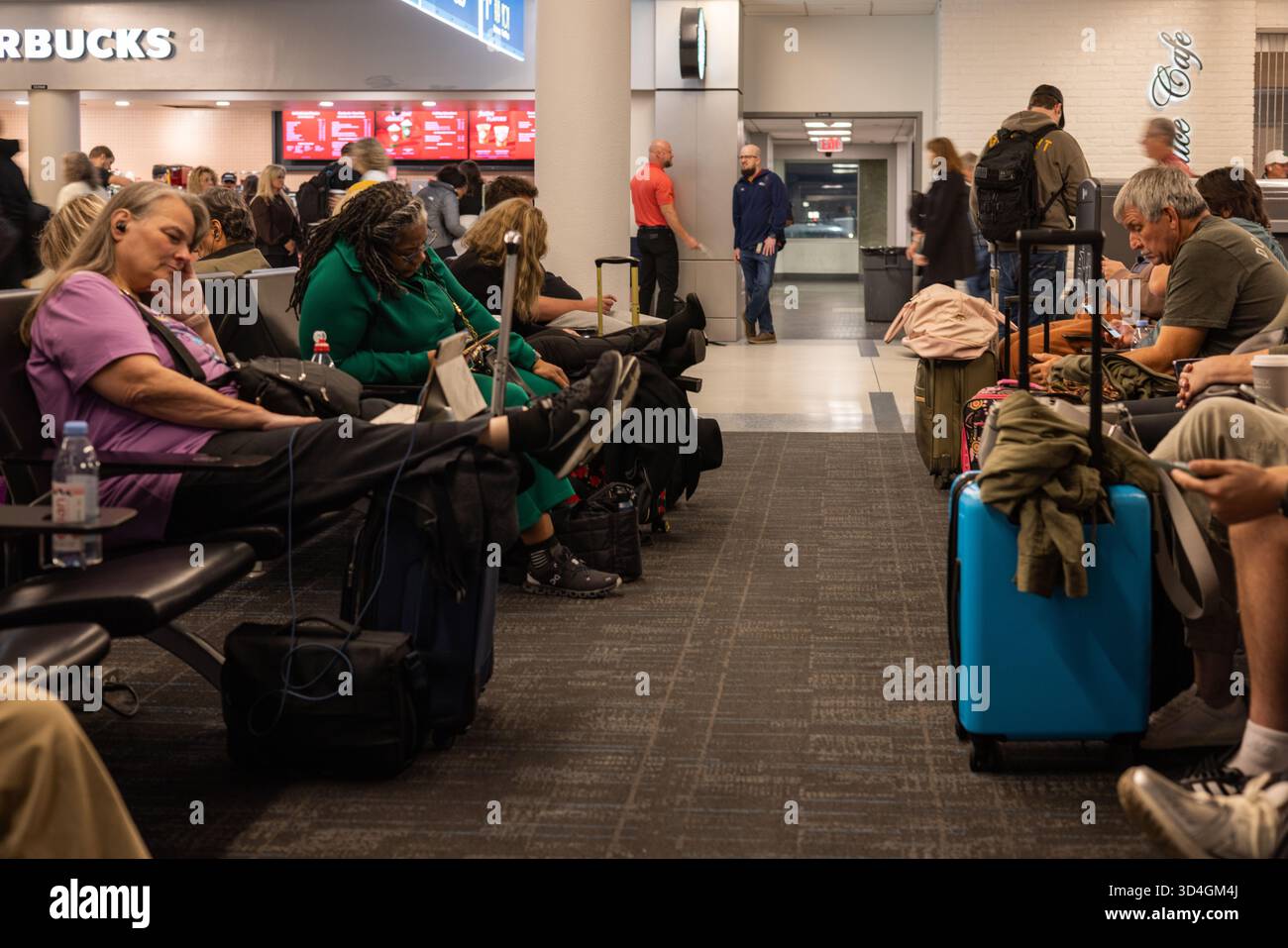 SAVANNAH, GEORGIA, Stati Uniti, 9 NOVEMBRE 2025: I passeggeri delle compagnie aeree aspettano in un'area affollata di gate terminal, con un po' di sonno o riposo, a Savannah/Hilton H. Foto Stock