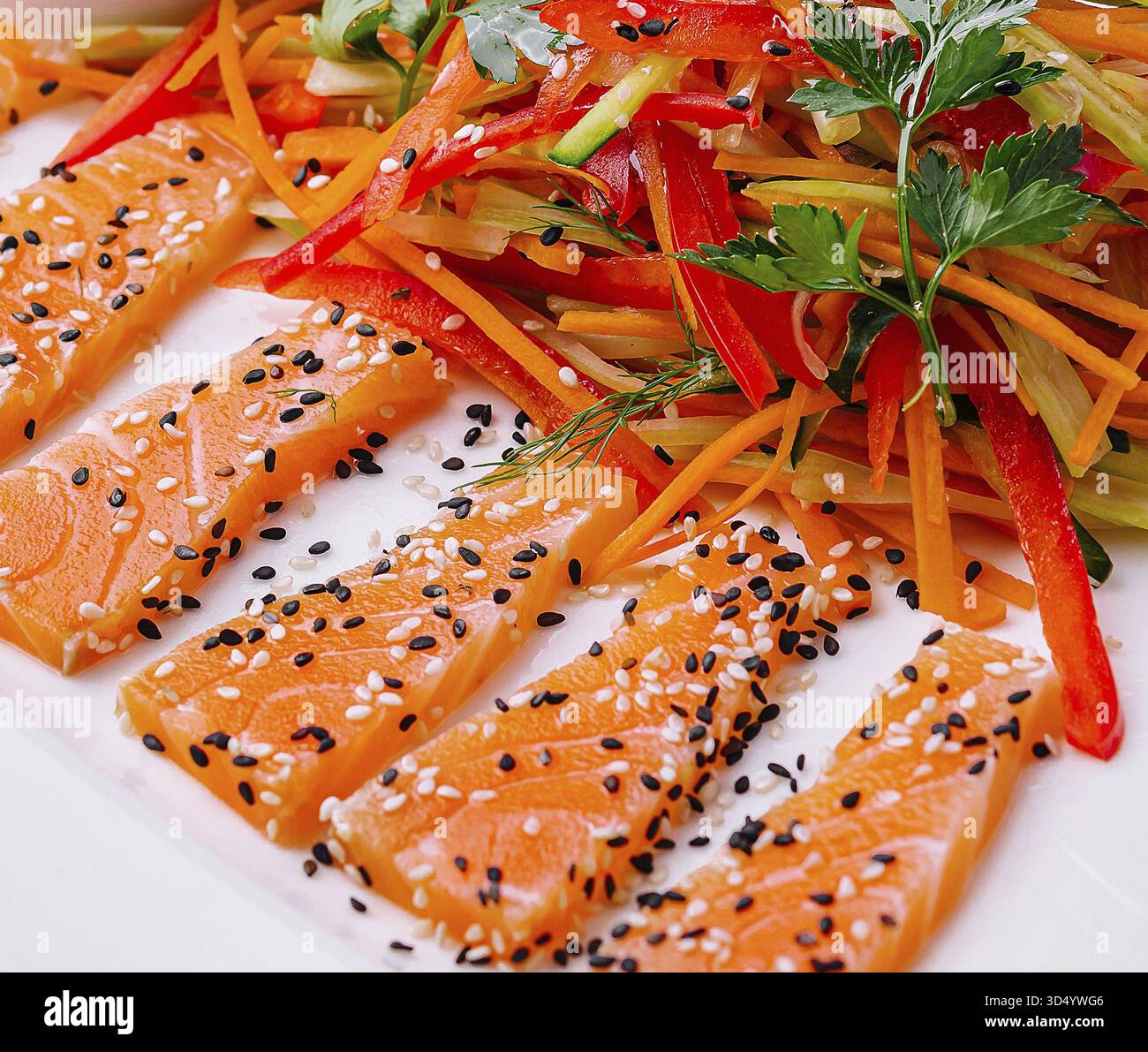 Cibo, fette di salmone con insalata di carote e peperoni e salsa di soia - cucina asiatica Foto Stock