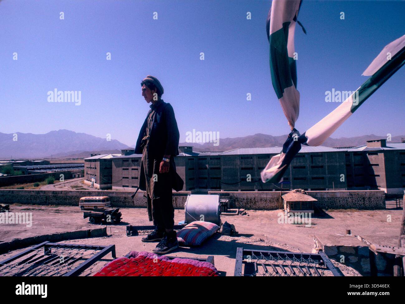 "AFGHANISTAN”, i mujahideen sorvegliano la prigione vuota di Kabul, nel 1992, con montagne ed edifici carcerari sullo sfondo. Foto Stock