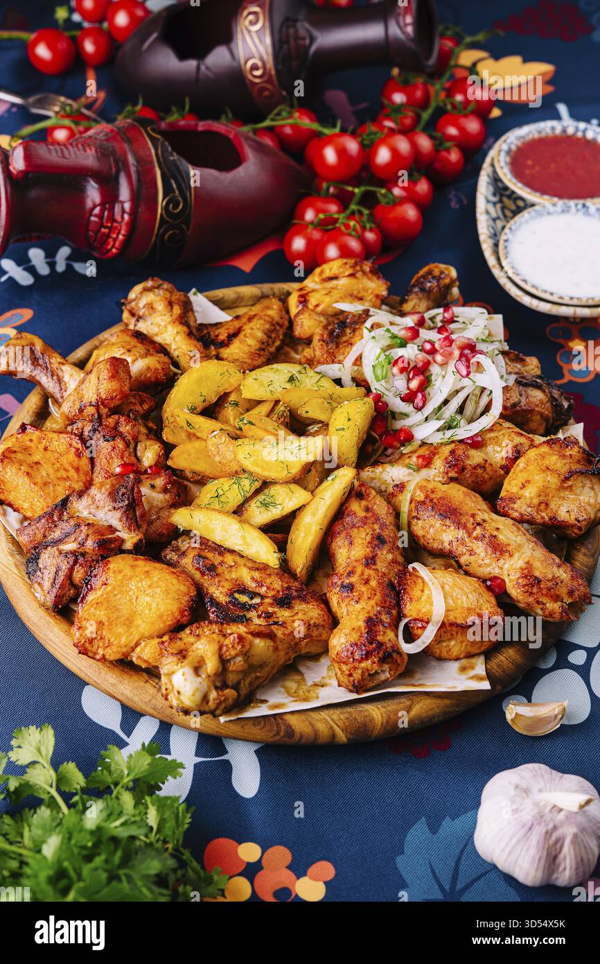 Cibo, piatto vivace di pollo alla griglia, patate aromatizzate e insalata fresca, perfetto per le riunioni Foto Stock