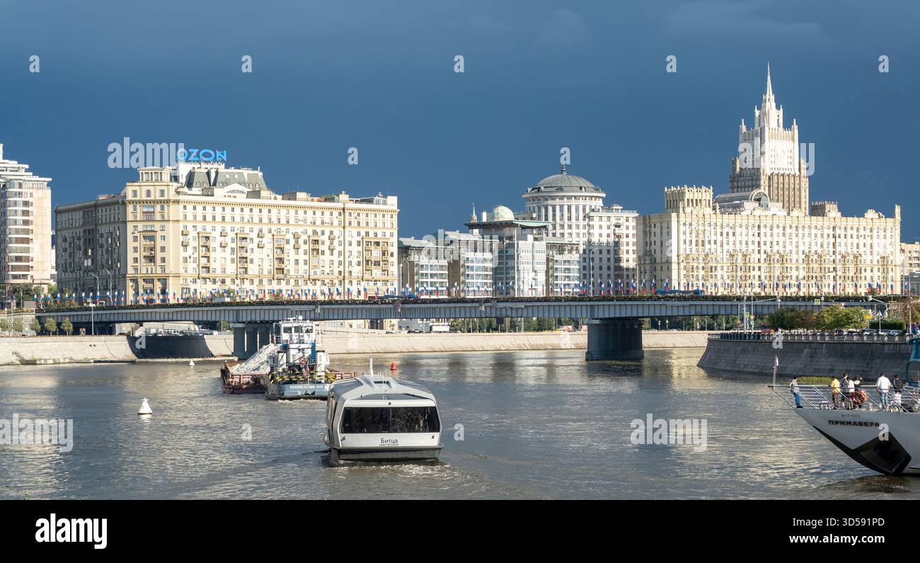 25 agosto 2025, Mosca, Russia. Il fiume riflette lo skyline di Mosca con un'architettura elegante, caratterizzata da barche che navigano sull'acqua e da un suggestivo clo Foto Stock