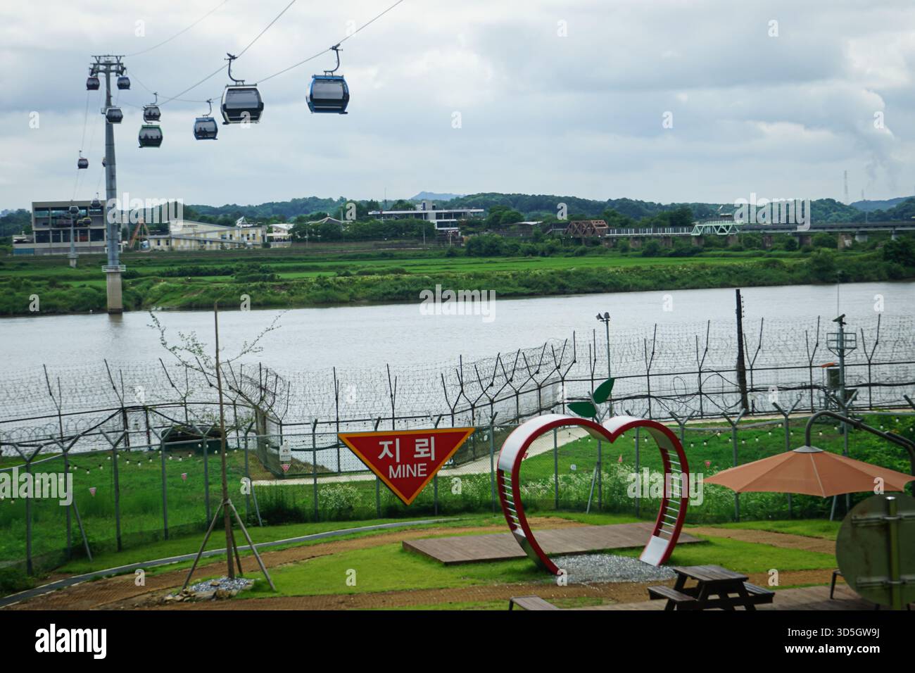 Le cabinovie passano sopra i cavi del fiume Imjingang accanto a un'area fotografica nel centro visitatori della gondola della Pace di Paju Imjingak nella DMZ coreana Foto Stock