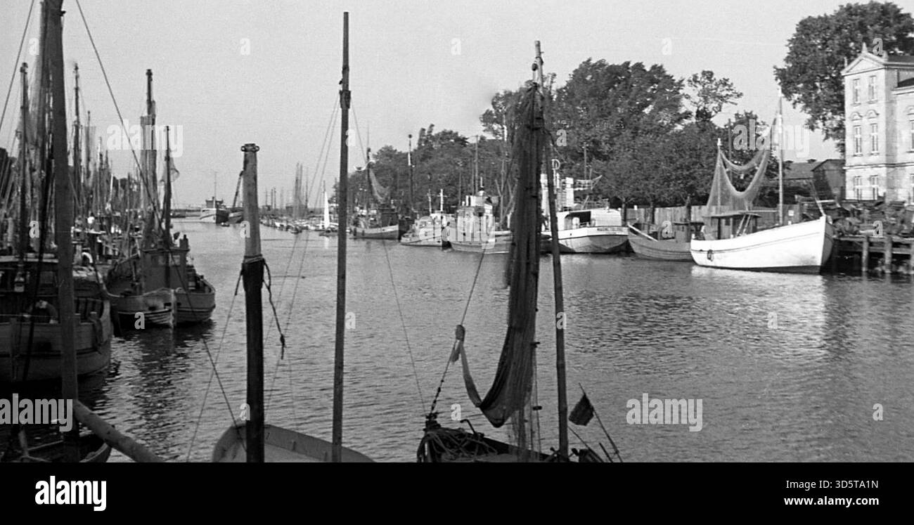I pescherecci decrepiti sopravvissuti alla guerra sono ormeggiati sul vecchio fiume di Warnemünde [traduzione automatica] Foto Stock