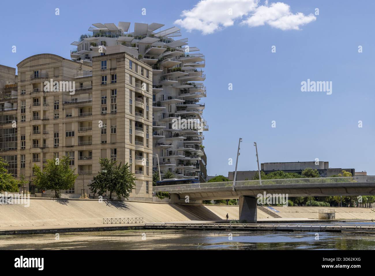 La vista di una suggestiva architettura si combina con il vecchio e il nuovo, mentre un moderno edificio bianco si erge dietro una classica struttura in pietra, Montpellier, Occitanie, Franc Foto Stock