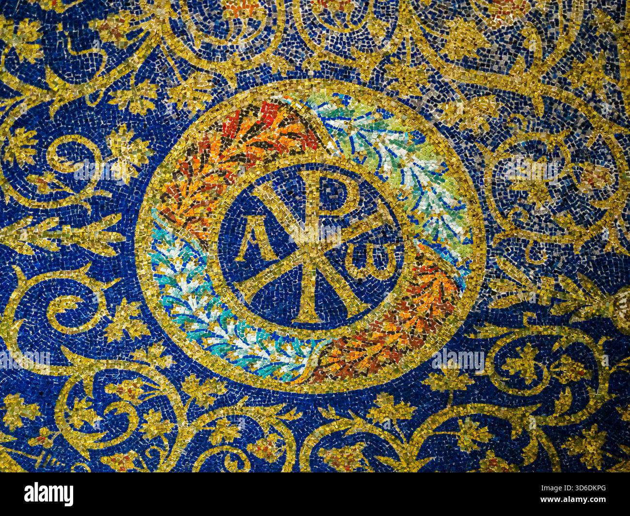 Mosaico raffigurante il monogramma di Cristo (Chrismon) affiancato dalle lettere Alfa e Omega (inizio e fine) immersi in una fioritura esuberante di vin Foto Stock