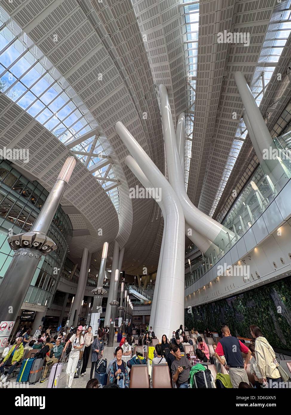 Stazione ferroviaria di West Kowloon. Gli interni affollati dell'atrio della stazione ferroviaria ad alta velocità di Hong Kong presentano un'architettura moderna e colonne bianche uniche Foto Stock