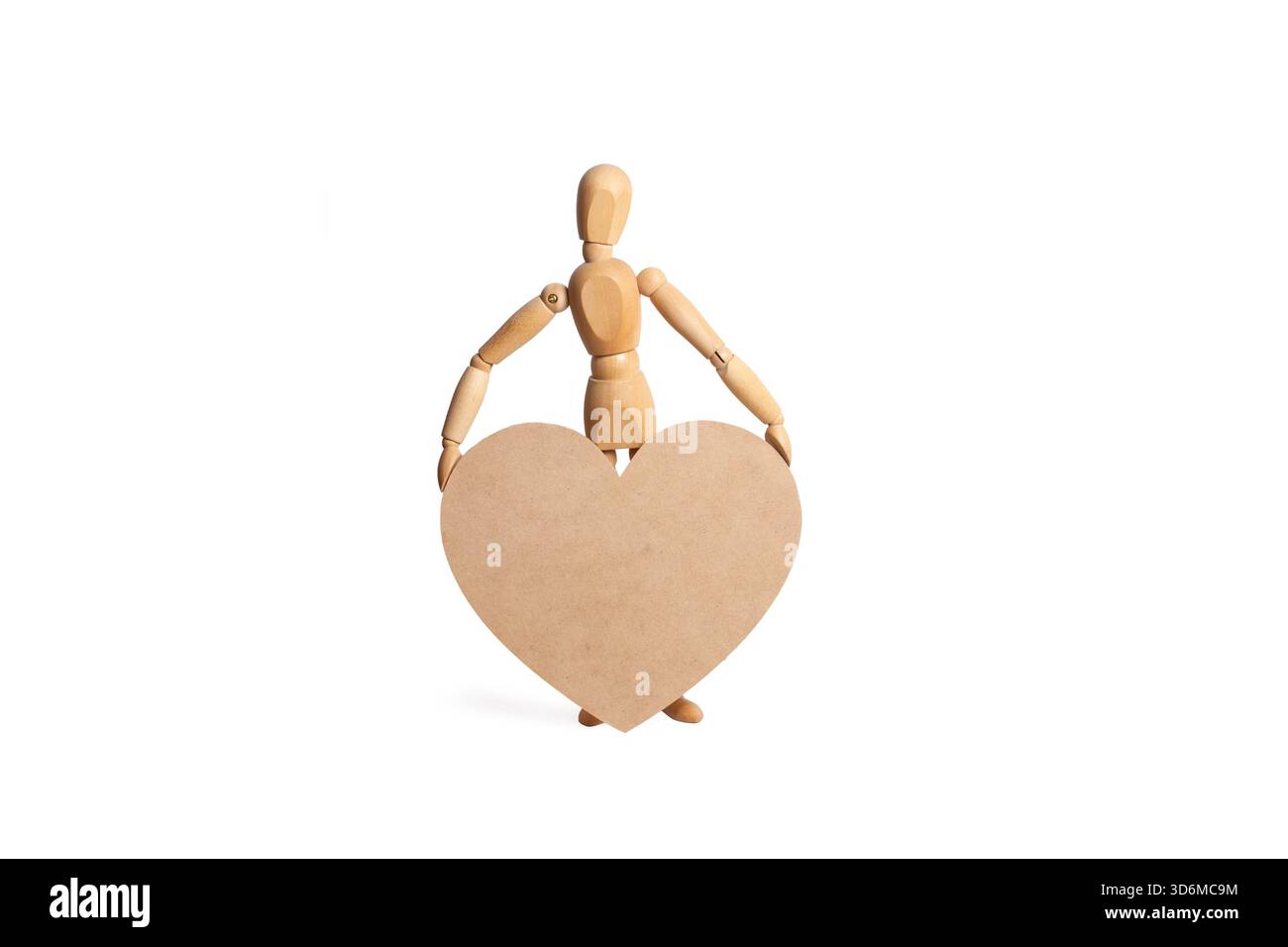 Un giocattolo manichino di legno che regge un grande cuore di legno su uno sfondo bianco con spazio per copiare Foto Stock